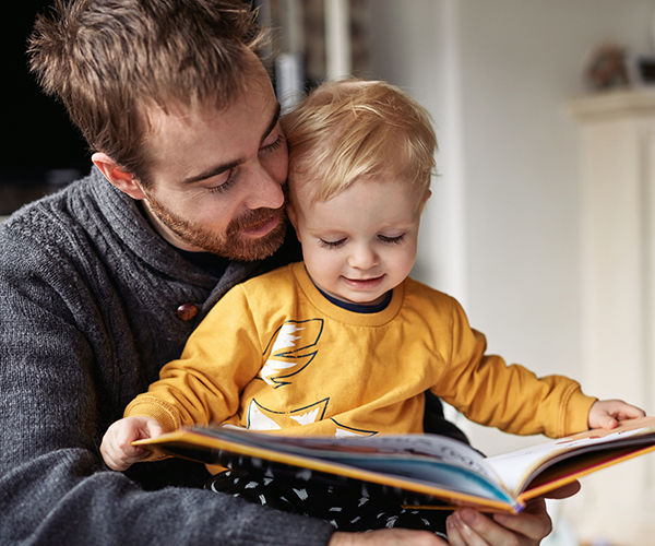 A man reading a story with his son