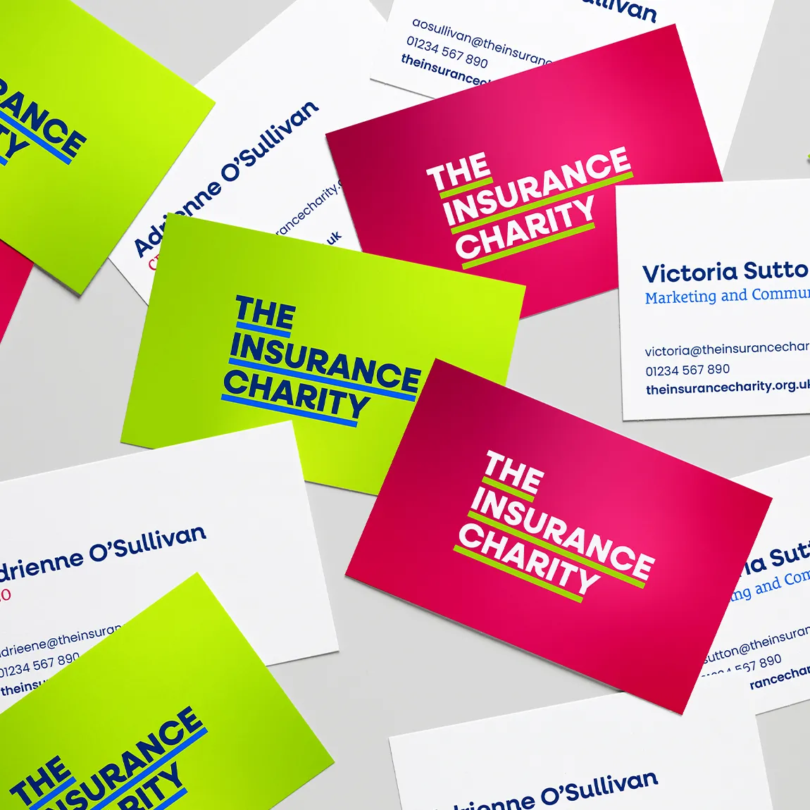 A collection of business cards with the logo on lime green and pink as well as contact details on the back