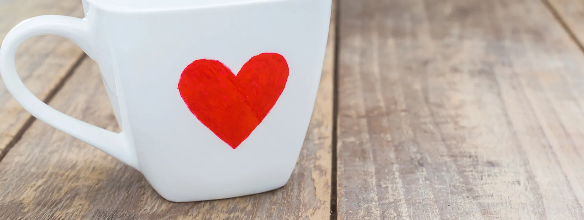 A white mug with a red heart on it